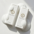 Two travel size bottles of Rare Elements shampoo and conditioner on a white background