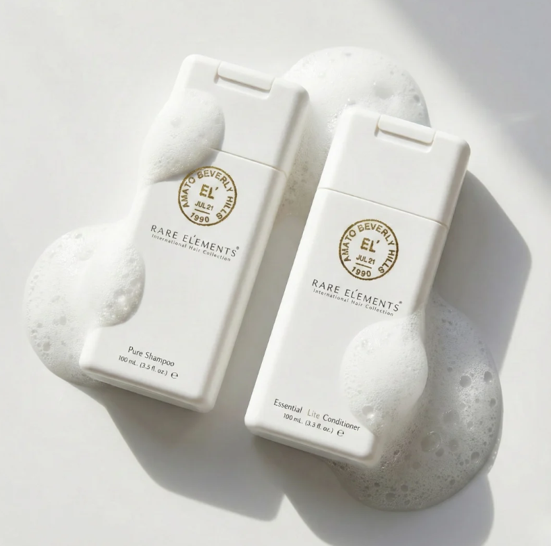 Two travel size bottles of Rare Elements shampoo and conditioner on a white background