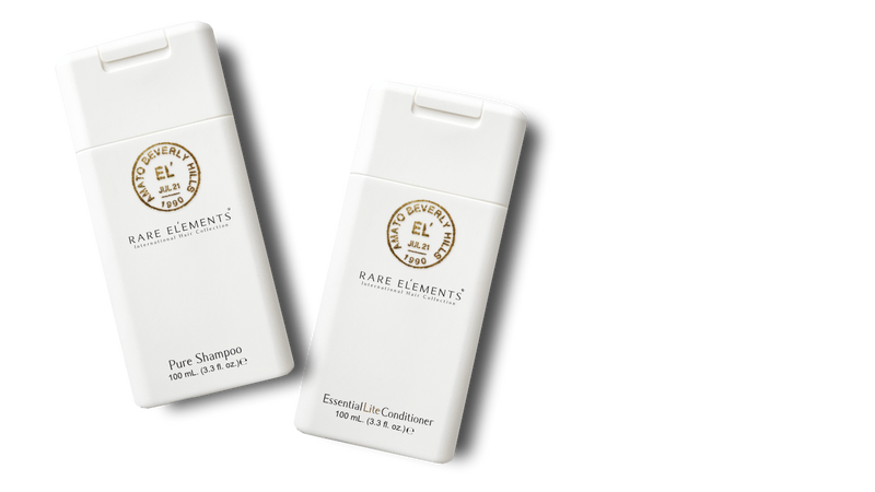Two white travel size shampoo and conditioner bottles with 'Rare Elements' branding on a white background.